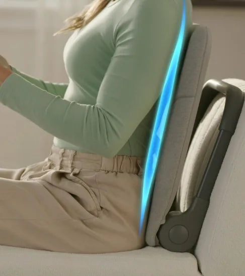 Woman sitting on a couch using the Ready Rocker for lumbar support